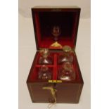 A 19th century rectangular mahogany case containing four spirit bottles with lined interior and