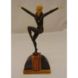 An Art Deco figurine of dancing lady in the style of Chiparus on an oval polychromatic marble stand,