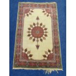 A Middle Eastern wool carpet cream ground with red and blue border, 219 x 136cm