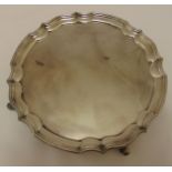 A hallmarked silver circular salver with Chippendale border on four volute scroll feet, Birmingham