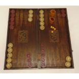 A Middle Eastern backgammon set in a carved wooden case