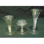 Two 19th century toasting glasses with spiral twist stems on circular spreading bases and a clear