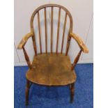 A Windsor elm wood elbow chair of customary form