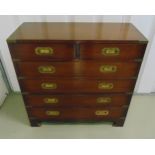 A mahogany campaign chest with brass brackets and inset swing handles, two scroll side handle on