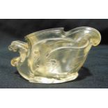 A Chinese carved crystal libation cup with bird handle and stylised wings on shaped oval base,