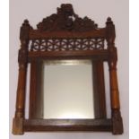 A late Victorian rectangular oak frame wall mirror carved with stylised flowers and leaves, and