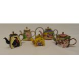 Five miniature enamel teapots of various form and shape decorated with figures and flowers