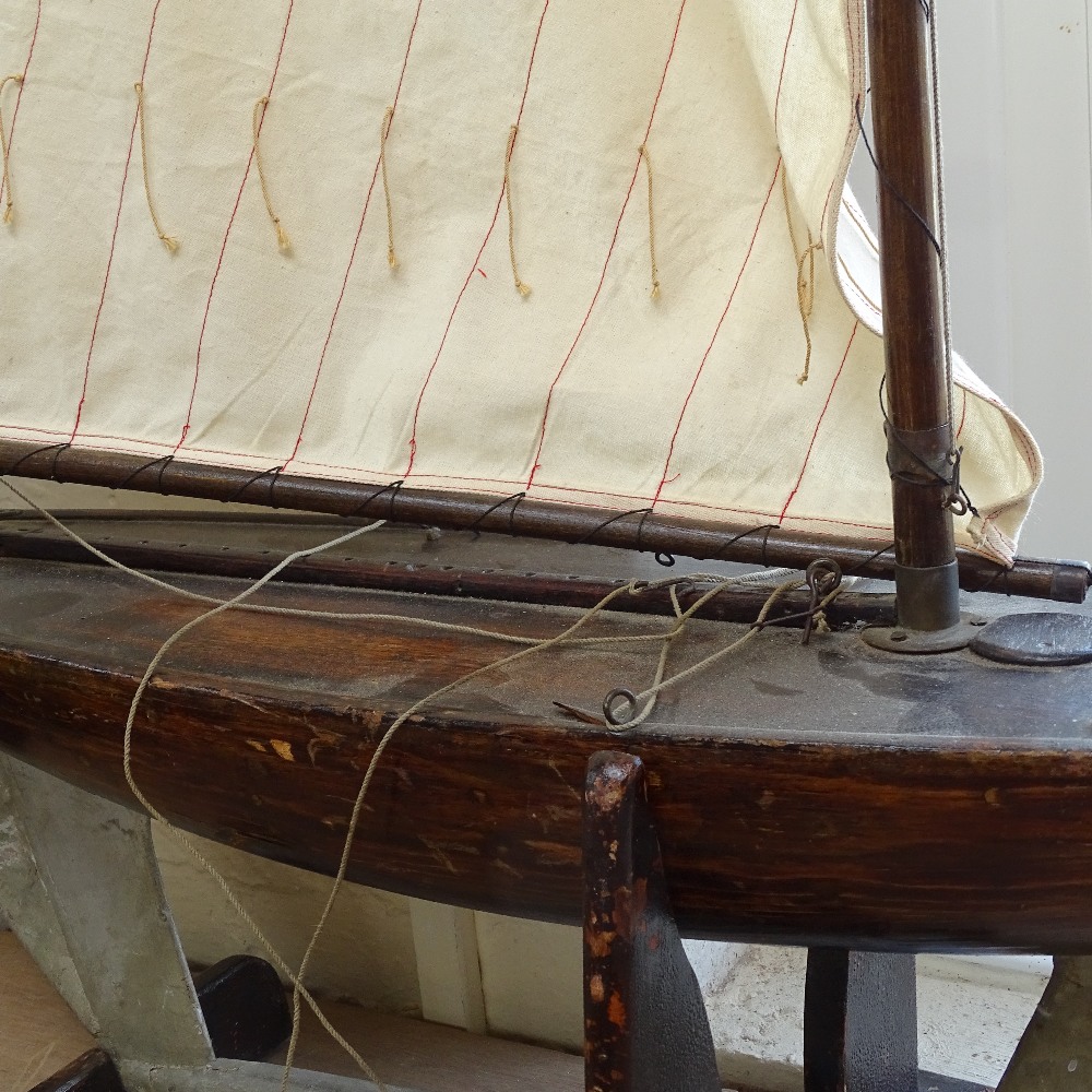 A large 19th century wooden hulled model pond yacht, with masts and rigging, hull length 82cm, on - Image 2 of 2