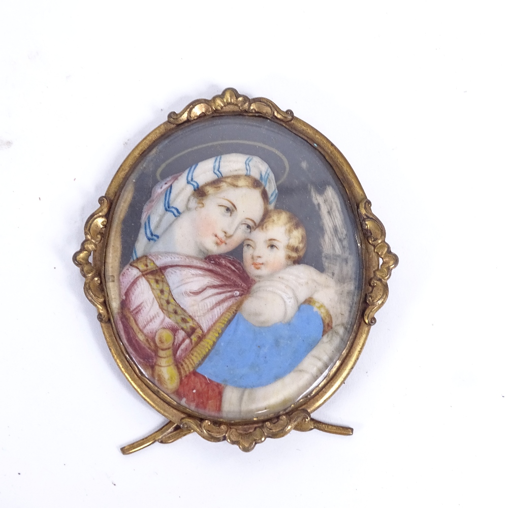 A 19th century miniature watercolour on ivory panel, Madonna and Child, in gilt-metal strut frame,