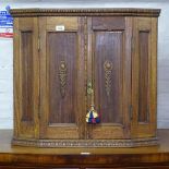 A small panelled oak 2-door hanging corner cupboard, W72cm, H66cm