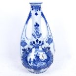 A Delft charger with painted floral decoration, 34cm, and a Delft James Burrough liqueur flagon