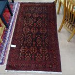 A red ground Persian design rug, 200cm x 110cm