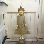 A large carved and painted South East Asian wooden figure on plinth, height 92cm