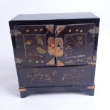 An early 20th century Japanese gilded black lacquer kodansu table-top jewellery cabinet, with