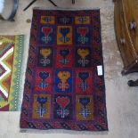 A red ground Beluchi rug, 131cm x 78cm