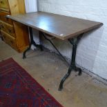 A rectangular oak-top garden table on shaped cast-iron base, W110cm, H70cm, D58cm