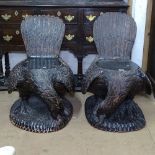 A pair of ornate carved chairs in the form of eagles