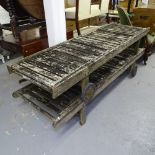 A pair of weathered teak garden loungers