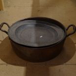 A large copper 2-handled jam pan, a large pewter charger etc
