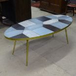 A contemporary design brushed brass-bound coffee table with inset panels, on brushed brass legs,