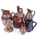 A glaze pottery lion, 16cm, a jug with moulded face design, glazed earthenware jugs etc
