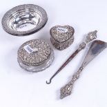 An Art Nouveau embossed silver heart-shape box, a silver-topped powder bowl, a silver-handled shoe