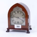 An early 20th century French mahogany-cased lancet-top 30-hour mantel clock, silvered dial with