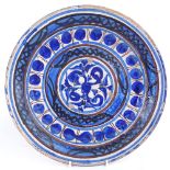 A 19th century European pottery charger, blue and white glaze decoration, diameter 32cm