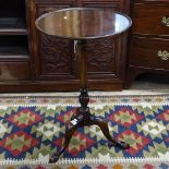 A mahogany wine table on tripod legs, with claw feet, H70cm