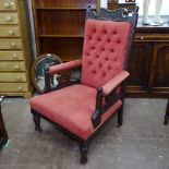 An Edwardian carved and mahogany-framed open arm parlour chair, with button-back upholstery