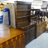 An oak 2-section dresser, with open plate rack and carved panelled doors, W92cm, H175cm