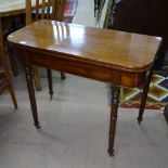 A Regency mahogany fold over tea table, on ring turned legs, W89cm, H72cm, D44cm