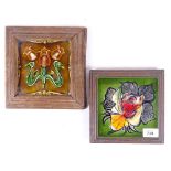 An Art Nouveau brown glaze floral tile, 14cm square, framed, and another (2)