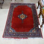 A red ground Persian design wool rug, 190cm x 140cm