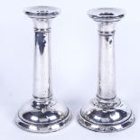 A pair of George V silver candlesticks of tapered form, on plinth base, height 18cm, hallmarks for