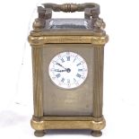 A French miniature brass-cased carriage clock, white enamel dial with blue Roman numeral hour
