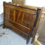 A Continental panelled walnut single bed