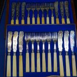 A Victorian fish service for 12 people, with engraved blades and ivorine handles in fitted case
