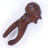 A 19th century German Black Forest Folk Art carved wood figural nutcracker, modelled as an elderly