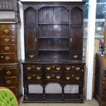 An Antique style oak 2-section dresser, top fitted with cupboards and open shelves, 6 short fitted