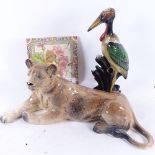 A large ceramic lioness figure, ceramic stork spill vase, and a transfer printed tile (3)