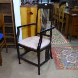 A Liberty & Co Arts and Crafts Langley armchair, with spindle back and stretcher detail