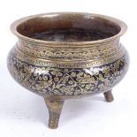 An Eastern bronze censer, on 3 feet with black enamel scrolled foliate frieze, diameter 14cm