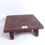 An 18th century carved oak Tudor Rose footstool, width 28cm, height 9cm