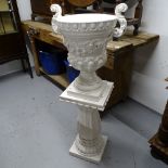 A Spanish white glazed ceramic 2-handled Campana urn on fluted pedestal base