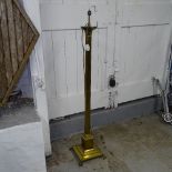 A brass Corinthian column standard lamp, on stepped base and lion paw feet, height to top of bayonet