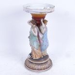 A 19th century porcelain stand supported by painted figures of The Three Graces, 30cm