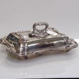 An ornate silver plate and copper tureen and cover, of serpentine form