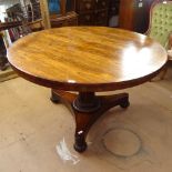 A Regency rosewood circular tilt-top breakfast table, on a reeded fluted column and trefoil base, on