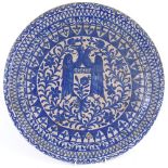 A large Hispano-Moresque blue and white pottery charger, with double-headed eagle decoration,